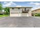 Two-story condominium complex featuring garages, a balcony, and well-maintained landscaping at 1250 S Monaco Pkwy # 67, Denver, CO 80224