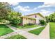 Charming home exterior with lush lawn, rock details, and inviting curb appeal at 1250 S Monaco Pkwy # 67, Denver, CO 80224