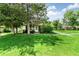 Charming home with a well-manicured lawn and mature trees providing shade and curb appeal at 1250 S Monaco Pkwy # 67, Denver, CO 80224