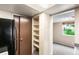 A kitchen featuring refrigerator, cabinets, open shelving, and connecting room at 1250 S Monaco Pkwy # 67, Denver, CO 80224