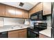 A kitchen featuring tile backsplash, oven, microwave, cabinets, and refrigerator at 1250 S Monaco Pkwy # 67, Denver, CO 80224