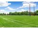 A vast, open green sports field is ready for play under a clear, partly cloudy sky at 1250 S Monaco Pkwy # 67, Denver, CO 80224
