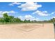 Outdoor sand volleyball court with net and green surroundings, inviting recreation and leisure at 1250 S Monaco Pkwy # 67, Denver, CO 80224