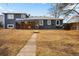 Exterior view of home with a spacious backyard, patio, and sunroom at 2930 S Birch St, Denver, CO 80222