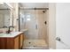 Modern bathroom featuring tiled walk-in shower with glass doors, and sleek vanity at 2930 S Birch St, Denver, CO 80222