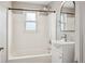 Bright bathroom features white tiled tub, shower, vanity, and fixtures at 2930 S Birch St, Denver, CO 80222