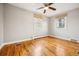 Sunlit bedroom with gleaming hardwood floors, two windows, and a ceiling fan at 2930 S Birch St, Denver, CO 80222