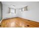 Bright and airy bedroom with hardwood flooring and multiple windows at 2930 S Birch St, Denver, CO 80222