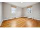 Sunlit bedroom with hardwood floors, two large windows and neutral walls at 2930 S Birch St, Denver, CO 80222