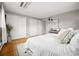 Bright bedroom featuring white bedding, hardwood floors, and ample closet space at 2930 S Birch St, Denver, CO 80222