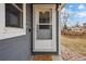 Close-up of the home's front door, with a peephole, door mat and sidelight window at 2930 S Birch St, Denver, CO 80222