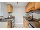 Functional kitchen with stainless steel appliances and wood cabinets at 2930 S Birch St, Denver, CO 80222