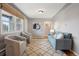 Cozy living room with a blue sofa, two gray chairs, and a patterned rug at 2930 S Birch St, Denver, CO 80222