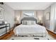 Inviting main bedroom featuring a gray headboard, patterned bedding, and hardwood floors at 2930 S Birch St, Denver, CO 80222