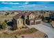 Stunning aerial view of the beautiful neighborhood and property with mature landscaping and a fenced backyard at 3214 Timeless Trl, Berthoud, CO 80513