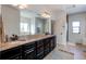 Bathroom showcasing dual sinks, granite counters, and dark wood cabinetry at 3214 Timeless Trl, Berthoud, CO 80513