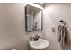 Powder room with a pedestal sink, modern faucet, and decorative mirror at 3214 Timeless Trl, Berthoud, CO 80513