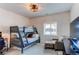 Well-lit bedroom featuring a bunk bed and a cozy seating area at 3214 Timeless Trl, Berthoud, CO 80513