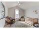 Bright bedroom with a crib, chair, and a serene, neutral color scheme at 3214 Timeless Trl, Berthoud, CO 80513