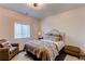 Comfortable bedroom with a plush bed, patterned bedding, and soft lighting at 3214 Timeless Trl, Berthoud, CO 80513