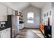 Breakfast nook with stainless steel appliances, vaulted ceiling, and ample natural light at 3214 Timeless Trl, Berthoud, CO 80513