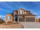 Charming two-story stucco and stone home featuring a three-car garage and a beautifully landscaped front yard at 3214 Timeless Trl, Berthoud, CO 80513