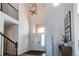 Bright foyer with high ceilings, a modern chandelier, and elegant staircase featuring wood floors at 3214 Timeless Trl, Berthoud, CO 80513