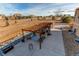 Dual pergolas on backyard patio with seating, decor, and grill, with expansive natural views beyond the property line at 3214 Timeless Trl, Berthoud, CO 80513