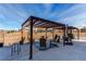 Outdoor pergola with stylish seating and decor creates a relaxing space for enjoying the peaceful backyard views at 3214 Timeless Trl, Berthoud, CO 80513