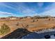 View of the expansive yard featuring a mix of vegetation and natural terrain extending beyond the property line at 3214 Timeless Trl, Berthoud, CO 80513