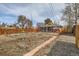 Expansive fenced backyard featuring a mix of grass and mulch, offering privacy and outdoor enjoyment at 1277 Wabash St, Denver, CO 80220