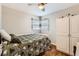 Bright bedroom featuring hardwood floors, natural light, and a built in storage unit at 1277 Wabash St, Denver, CO 80220