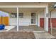 Inviting covered front porch with a secure screen door and convenient house number display at 1277 Wabash St, Denver, CO 80220