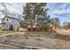 Charming single story home with a well manicured lawn and a large tree, fenced in yard at 1277 Wabash St, Denver, CO 80220