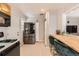 Well-lit kitchen features wooden cabinets, stainless steel refrigerator, and modern appliances at 1277 Wabash St, Denver, CO 80220