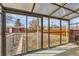 Sun room with glass windows overlooking backyard, perfect for enjoying nature views at 1277 Wabash St, Denver, CO 80220