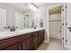 Well-lit bathroom with double vanity, tiled floors, and shower/tub combo at 3493 Princeton Pl, Broomfield, CO 80023