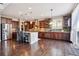 Spacious kitchen featuring stainless steel appliances, ample counter space, and dark wood cabinetry at 3493 Princeton Pl, Broomfield, CO 80023