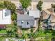 An aerial view of the backyard with large deck, landscaping and privacy fence, and mature trees at 14091 W Exposition Dr, Lakewood, CO 80228