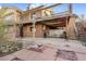 Brick home exterior with a patio featuring a fire pit and multi-level deck above at 14091 W Exposition Dr, Lakewood, CO 80228