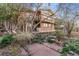 Home's backyard featuring brick exterior and lots of greenery at 14091 W Exposition Dr, Lakewood, CO 80228