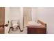 Cozy bathroom featuring a shower and ceramic sink with vanity, and toilet at 14091 W Exposition Dr, Lakewood, CO 80228