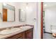 This bathroom features double sinks, mirrors, and a shower with curtain at 14091 W Exposition Dr, Lakewood, CO 80228