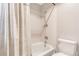 An updated bathroom is shown with a shower-tub combination and commode at 14091 W Exposition Dr, Lakewood, CO 80228