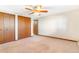 This bedroom features a ceiling fan and closet at 14091 W Exposition Dr, Lakewood, CO 80228