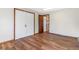 Bright bedroom with hardwood floors, closet and access to another room at 14091 W Exposition Dr, Lakewood, CO 80228