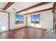 Bright dining room features wood floors, beams, and scenic views from the two windows at 14091 W Exposition Dr, Lakewood, CO 80228