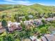 An exterior shot of the house with a large deck and lush landscaping against a scenic mountain backdrop at 14091 W Exposition Dr, Lakewood, CO 80228