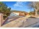 Brick home with an attached two-car garage and a brick driveway and landscaping at 14091 W Exposition Dr, Lakewood, CO 80228