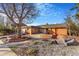 Charming brick home featuring a beautifully landscaped front yard and walkway at 14091 W Exposition Dr, Lakewood, CO 80228